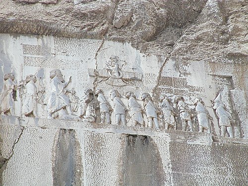 The Behistun relief and inscription carved into a cliff face in western Iran