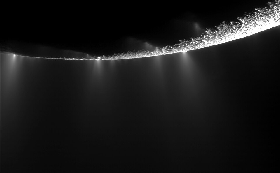 Plumes of ice erupting from the south pole of Enceladus, backlit by the Sun