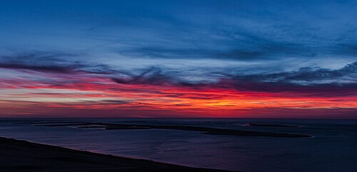 A large sand dune at sunset