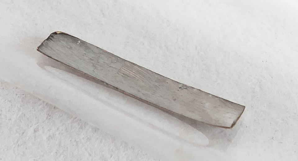 A small sample of metallic technetium in a glass vial